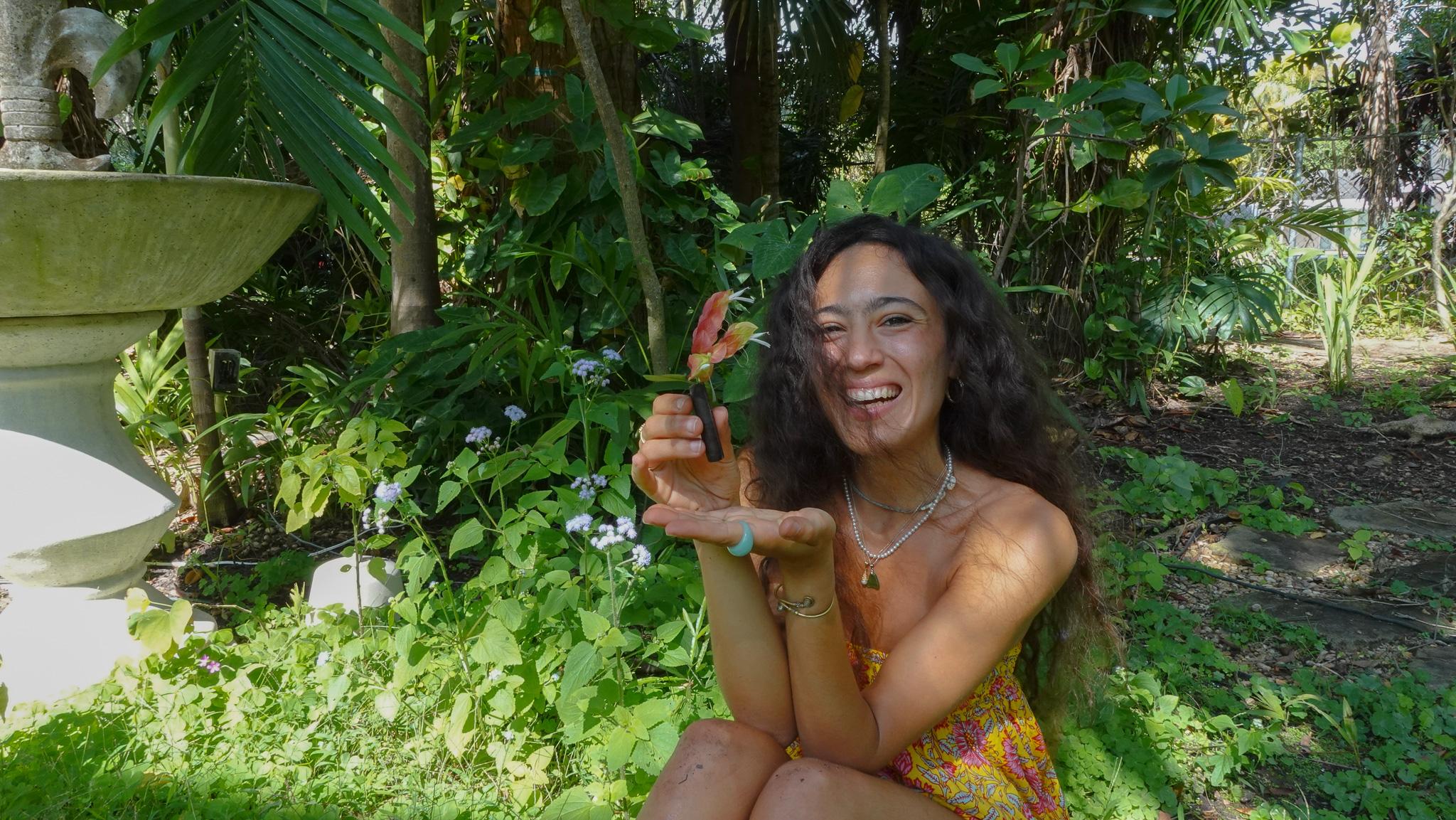 Shelliour founder in a garden holding the refillable mascara